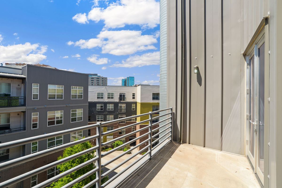 Apartment balcony overlooking a courtyard of mid-rise buildings