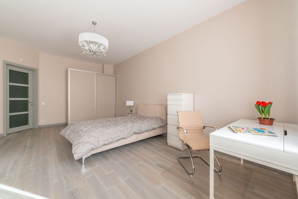 Furnished bedroom with a writing desk and chair