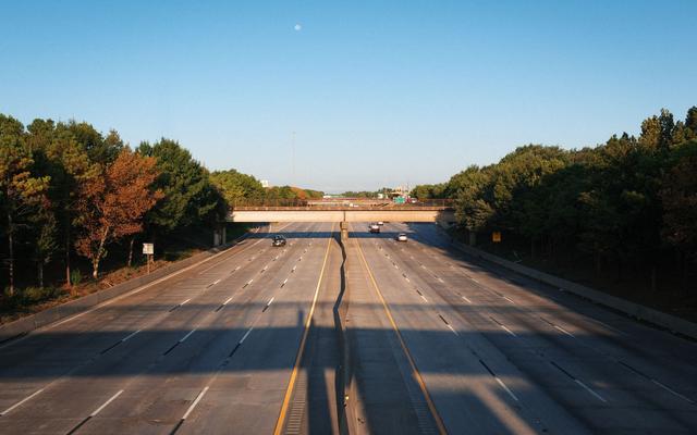 Wide freeway lanes under early morning light