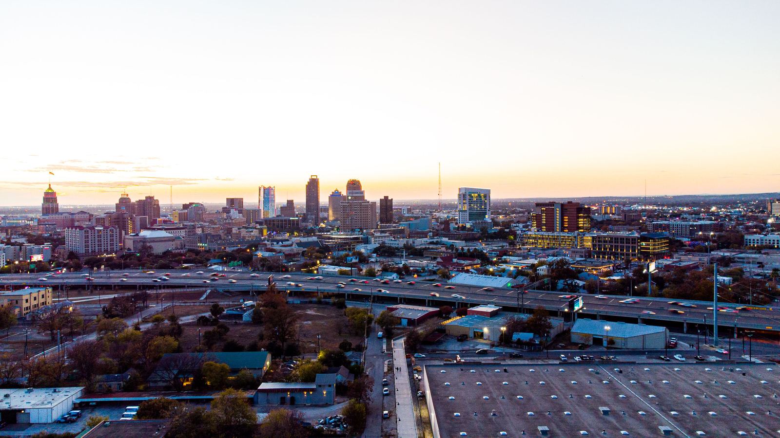 Downtown San Antonio skyline at dusk above the interstate