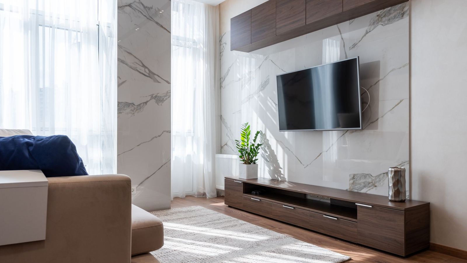 Furnished apartment living room with a wall-mounted television