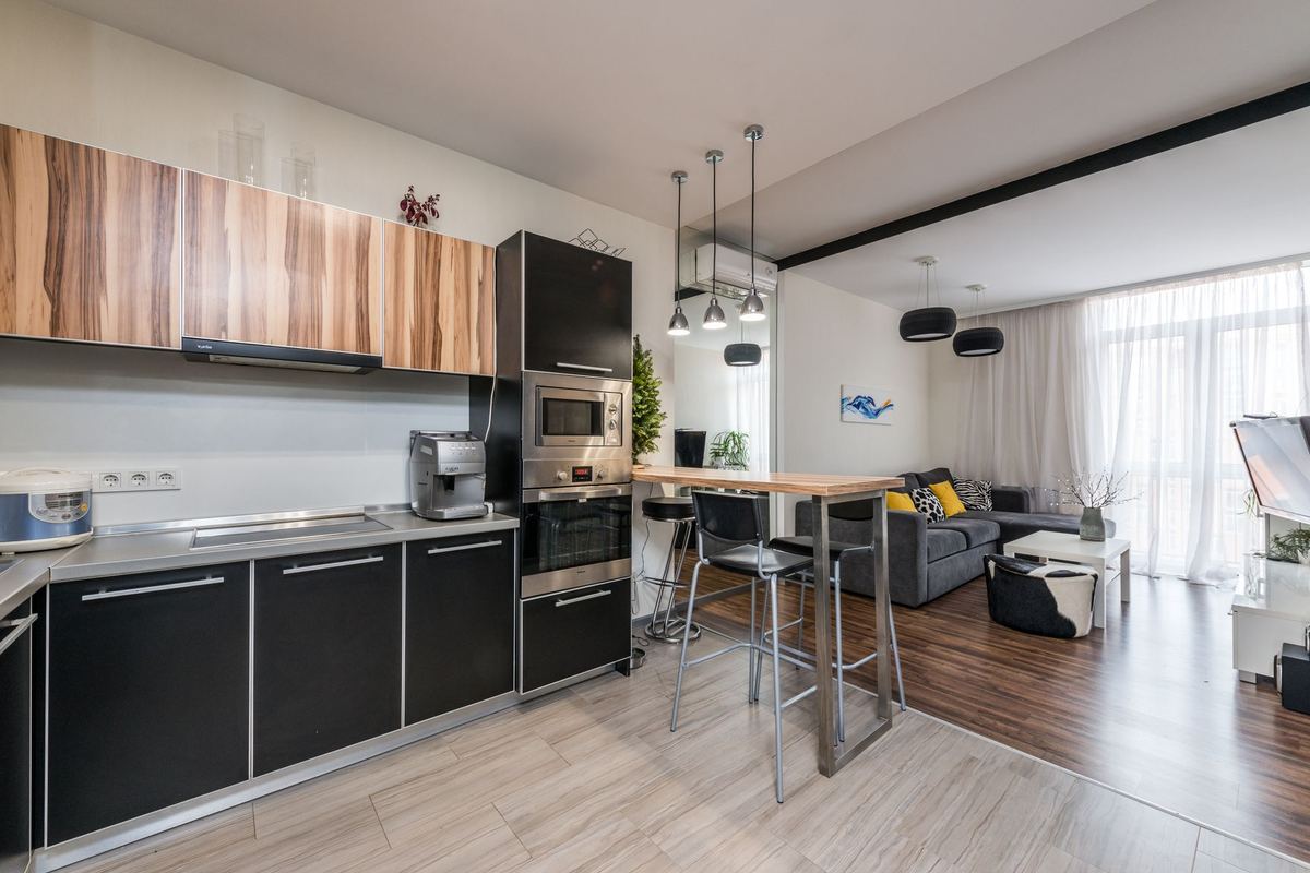 Apartment kitchen with a breakfast bar opening onto the living area