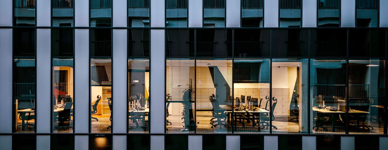 Office building facade with lit windows at dusk