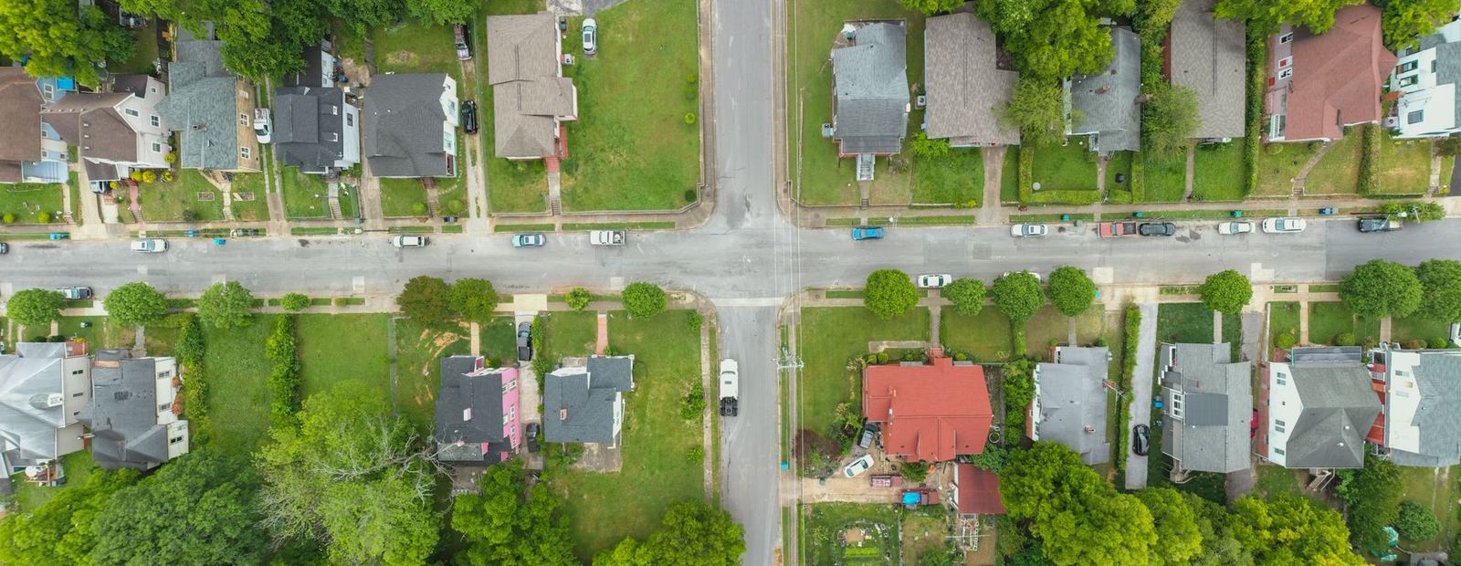 Aerial view of a residential crossroads and tree-lined streets