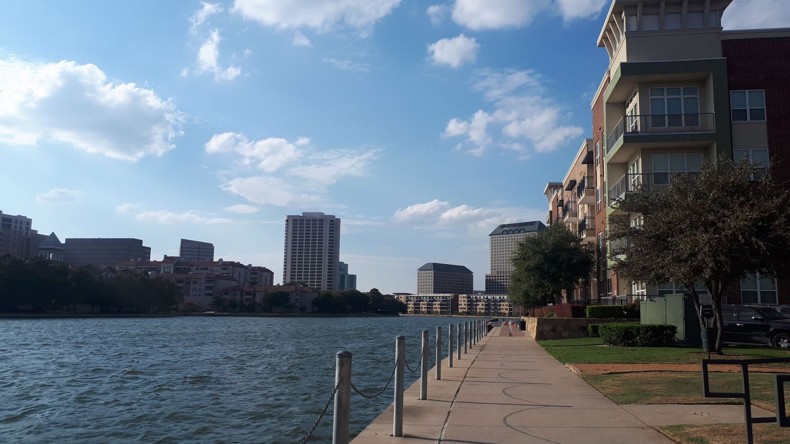 Waterside walkway past mid-rise apartment buildings