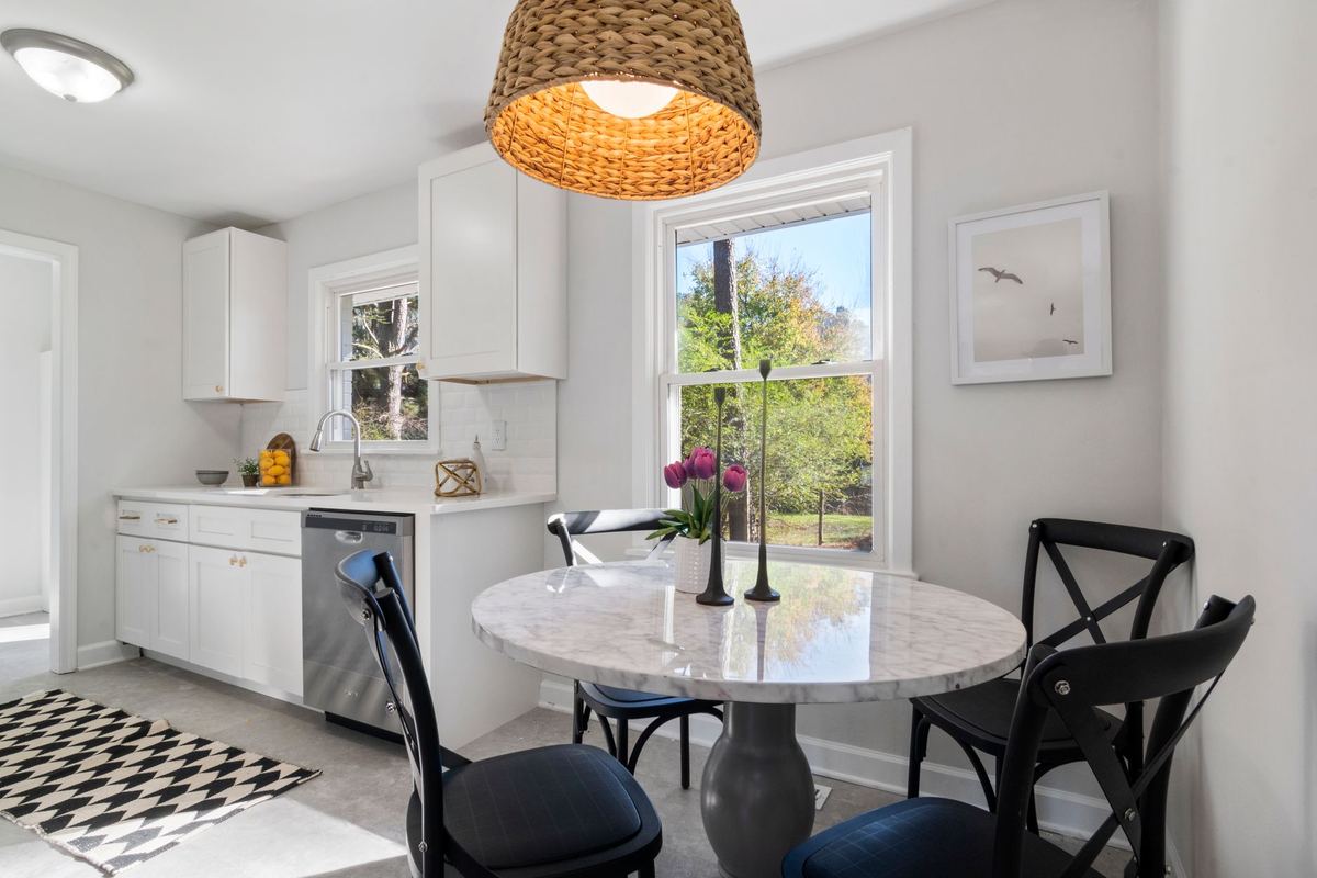 White kitchen with a round marble bistro table