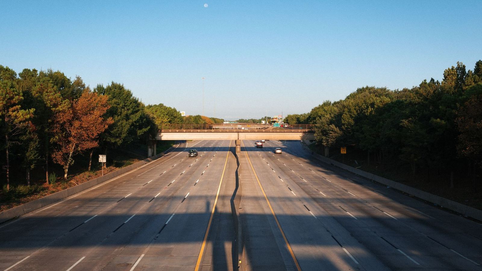 Wide freeway lanes under early morning light
